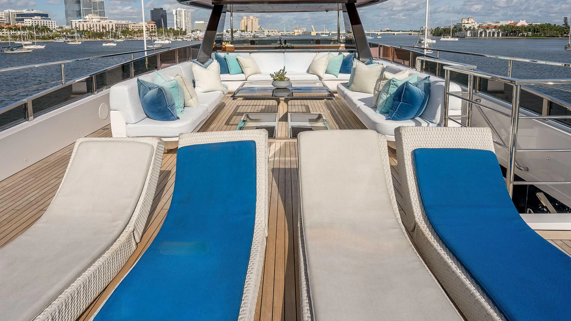 a deck with a large deck and a view of a city aboard NAMASTE Yacht for Sale