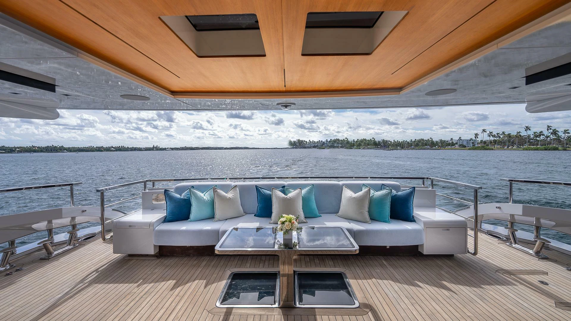 a large white couch on a deck overlooking a body of water aboard NAMASTE Yacht for Sale