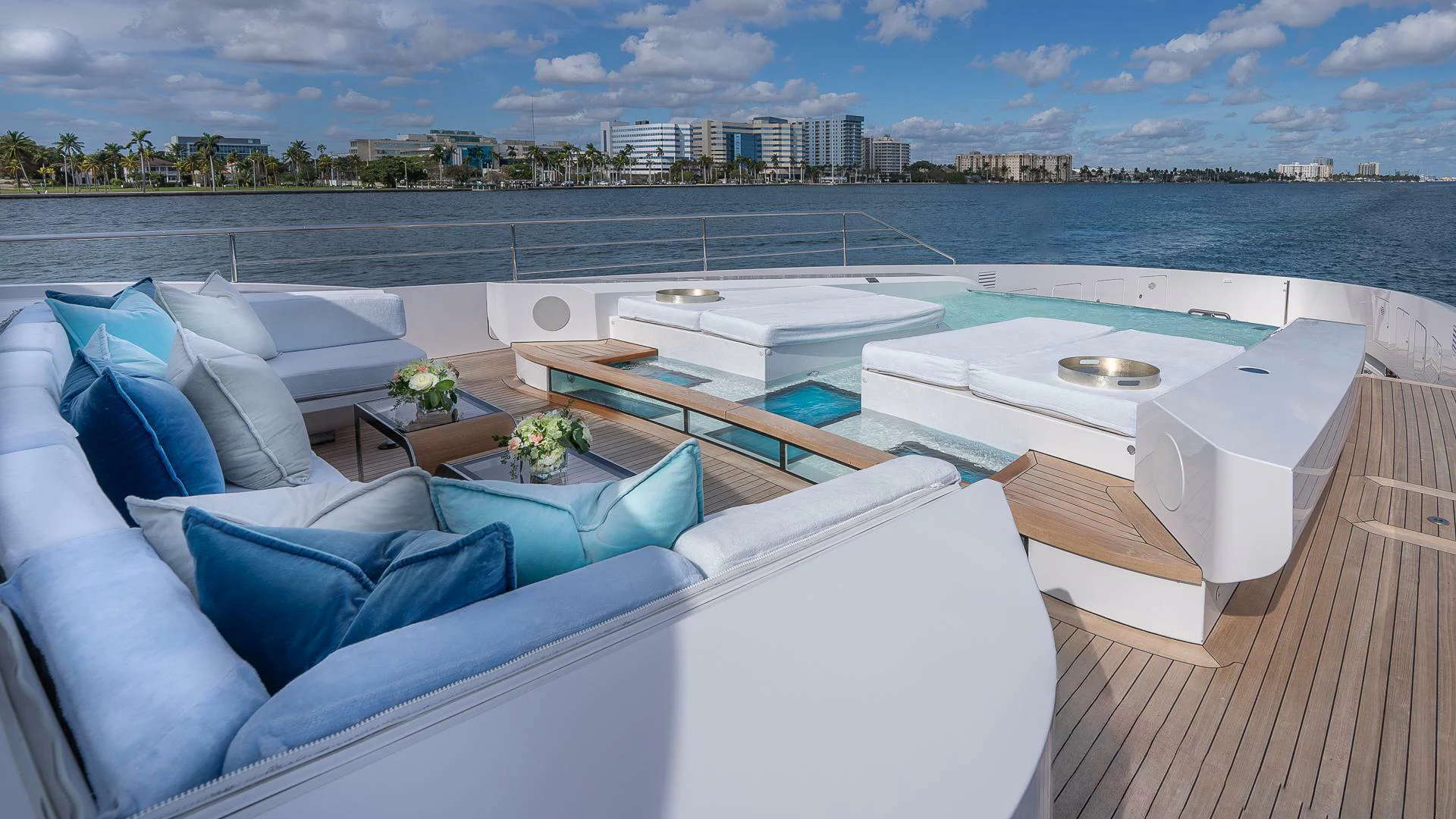 a large white lounge chair on a deck overlooking a large body of water aboard NAMASTE Yacht for Sale