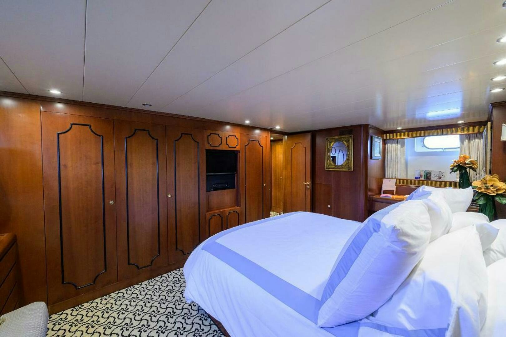 a room with wooden cabinets aboard CIPANGO Yacht for Sale