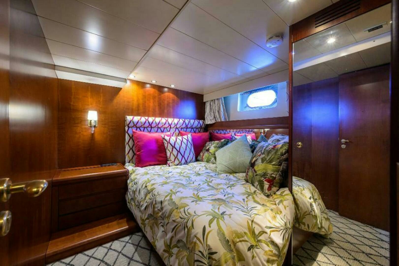 a room with a bed and a mirror aboard CIPANGO Yacht for Sale
