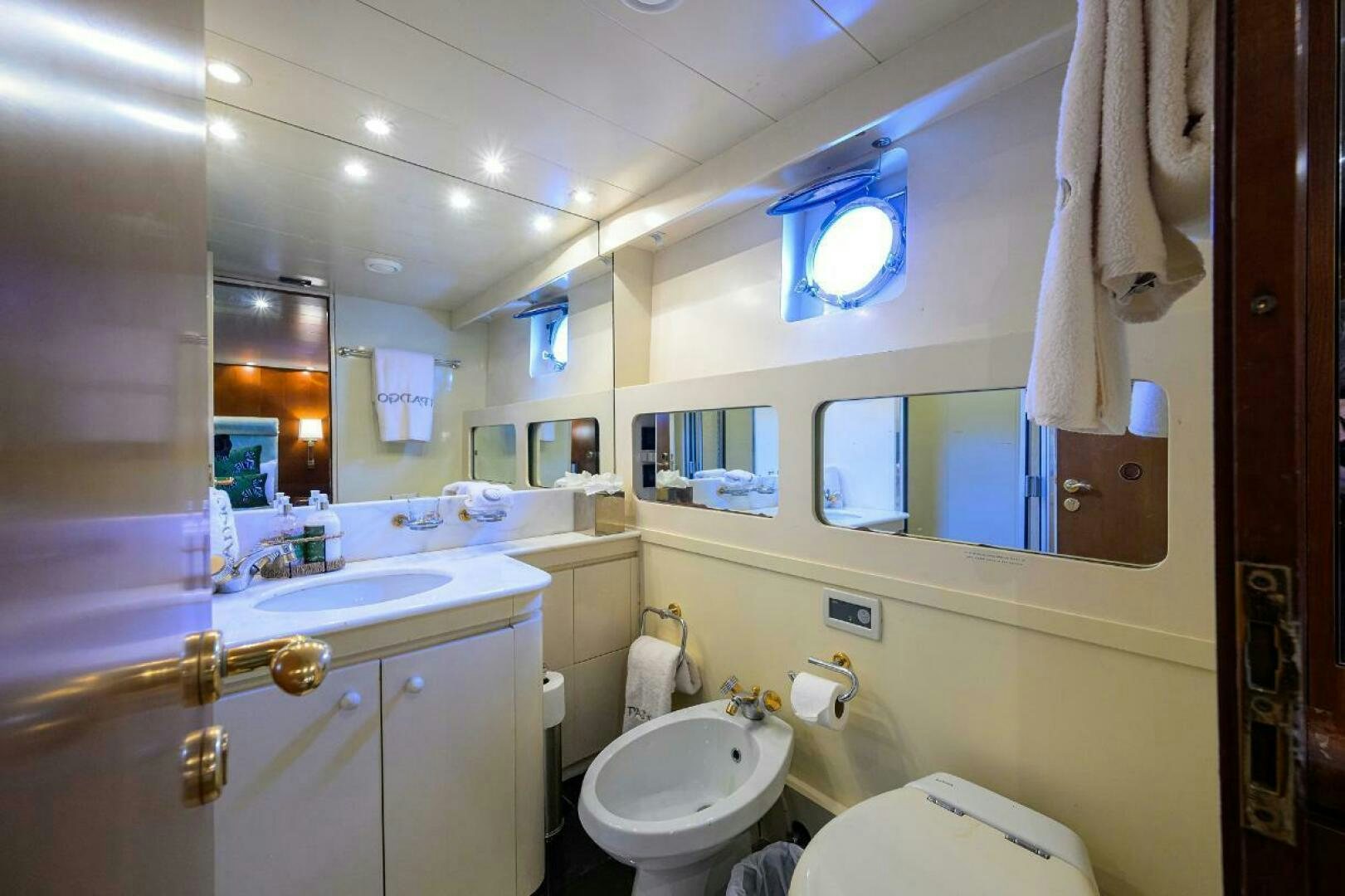 a bathroom with a toilet and sink aboard CIPANGO Yacht for Sale