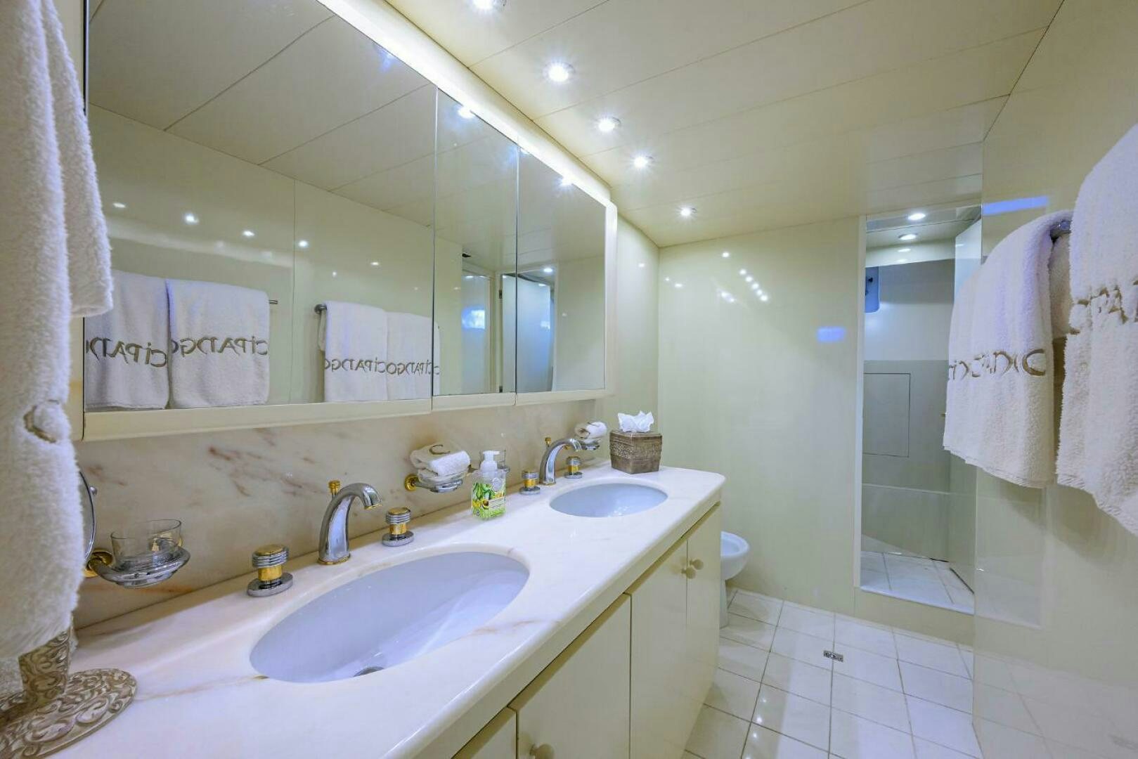 a bathroom with a sink and a mirror aboard CIPANGO Yacht for Sale