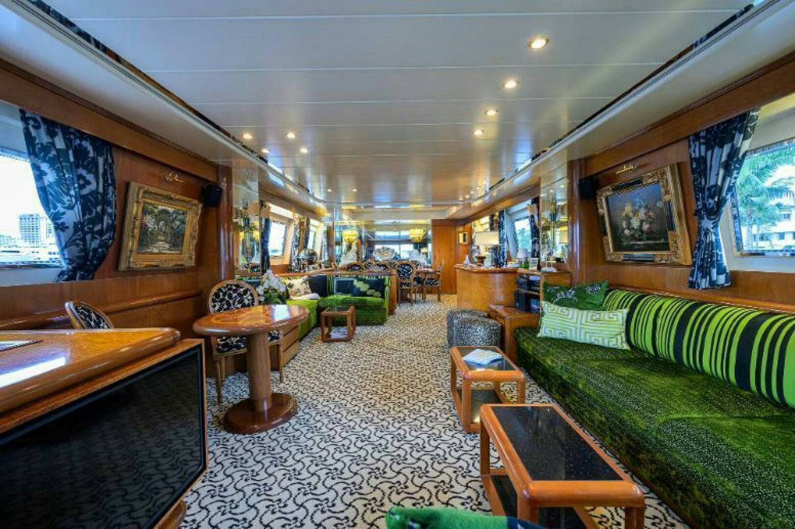 a living room with a couch and a table aboard CIPANGO Yacht for Sale