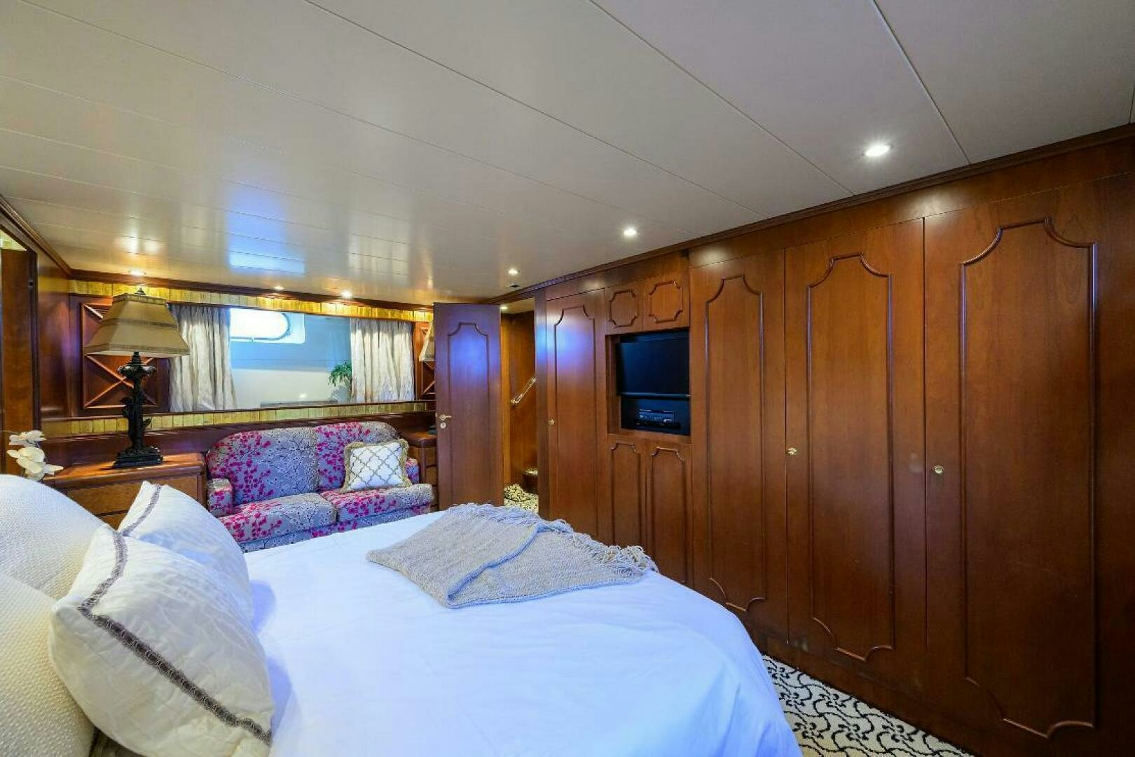 a room with a bed and a television aboard CIPANGO Yacht for Sale