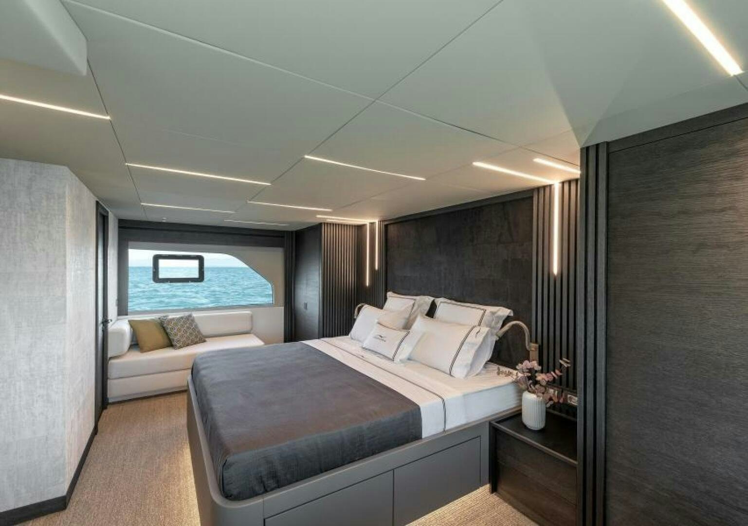 a bedroom with a bed and a window aboard NUMARINE 22XP/07 Yacht for Sale
