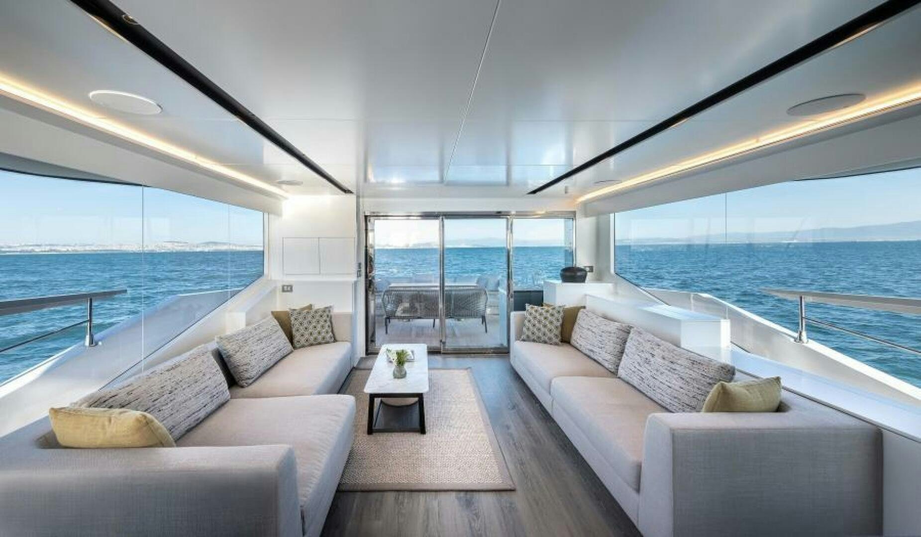 a living room with a large window overlooking the ocean aboard NUMARINE 22XP/07 Yacht for Sale