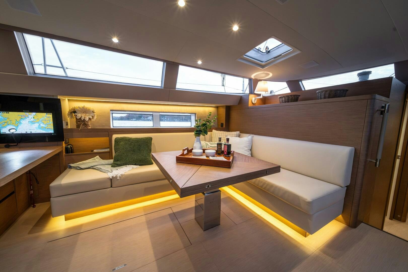 a living room with a couch and a coffee table aboard FORTITUDE Yacht for Sale