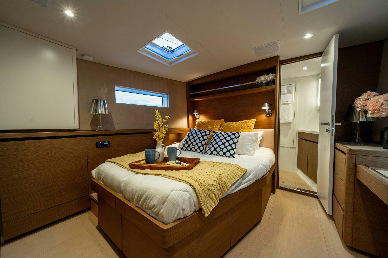 a bedroom with a bed and a desk aboard FORTITUDE Yacht for Sale
