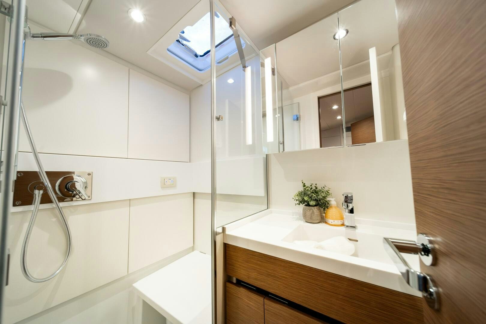 a bathroom with a shower and sink aboard FORTITUDE Yacht for Sale