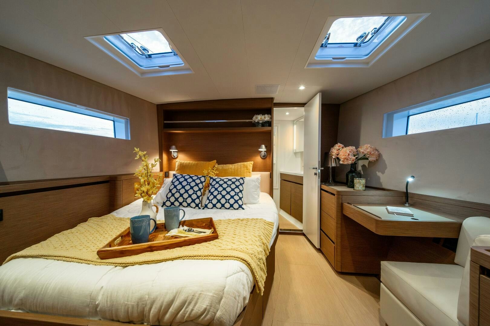 a hotel room with a bed and desk aboard FORTITUDE Yacht for Sale
