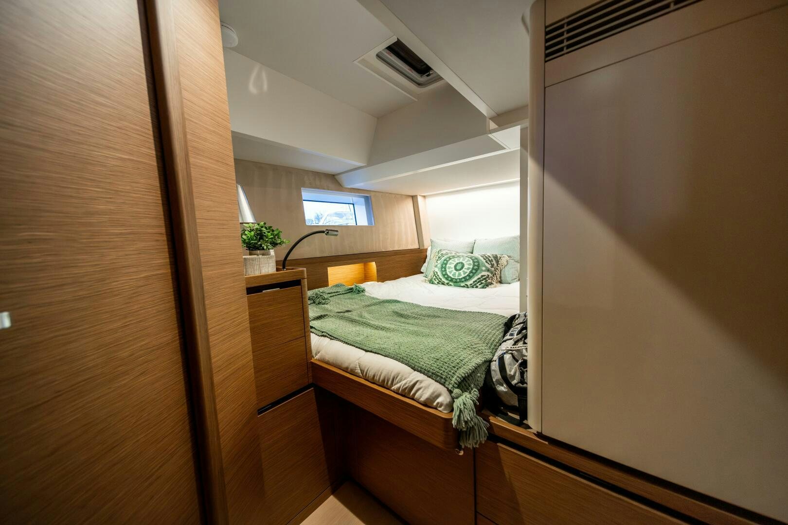 a bedroom with a bed and a desk aboard FORTITUDE Yacht for Sale