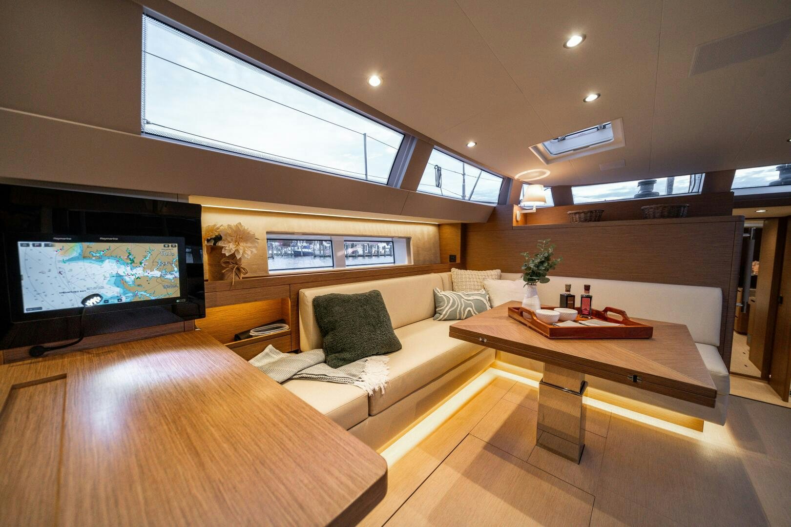 a living room with a tv and a couch aboard FORTITUDE Yacht for Sale