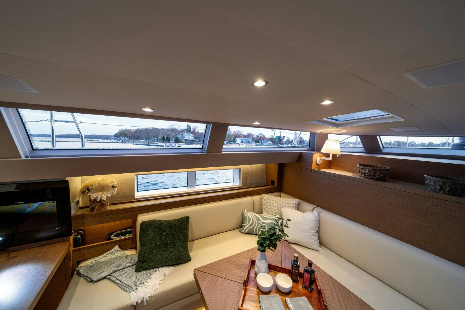 a room with a couch and a table and a television aboard FORTITUDE Yacht for Sale