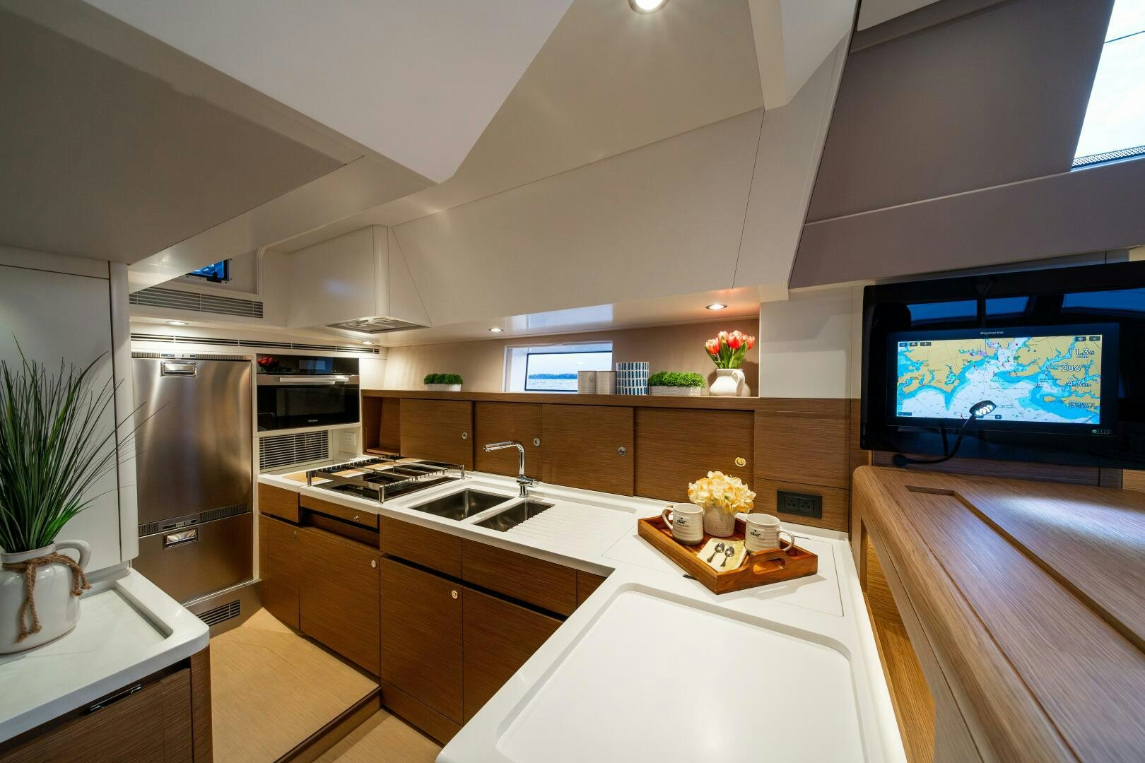 a kitchen with a tv on the wall aboard FORTITUDE Yacht for Sale