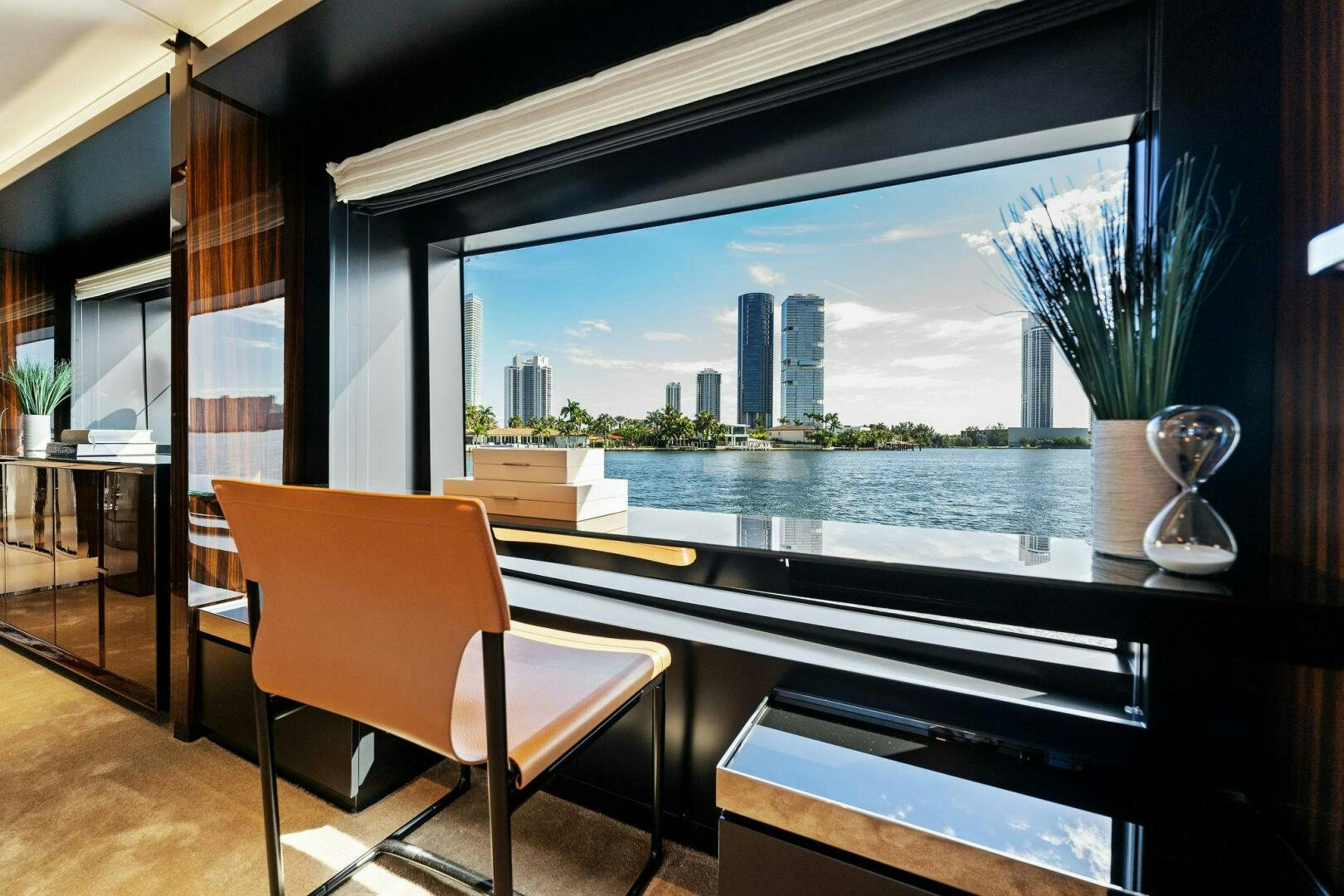 a room with a table and chairs and a view of a city aboard CORSARO SUPER Yacht for Sale