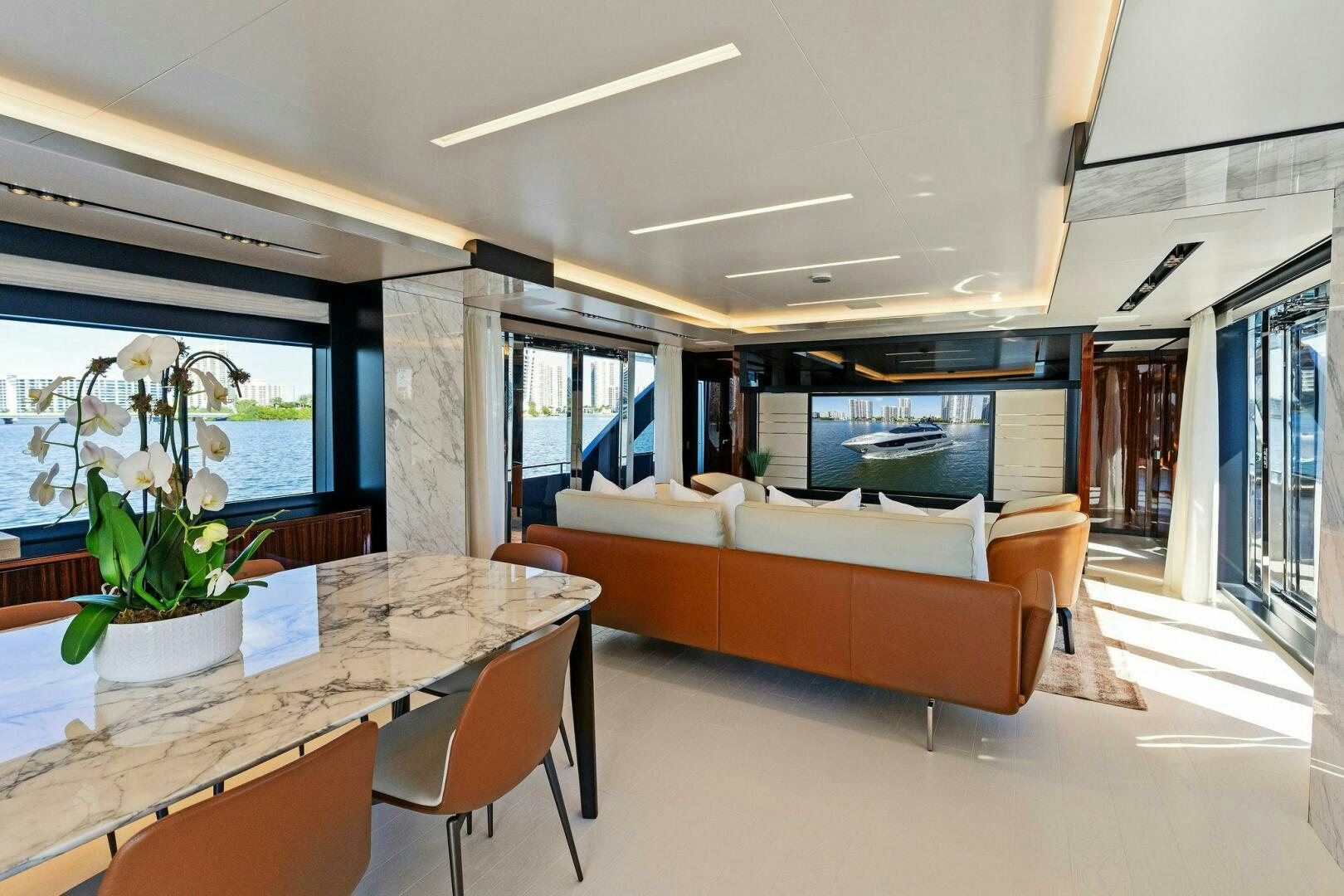 a living room with a table and couches aboard CORSARO SUPER Yacht for Sale