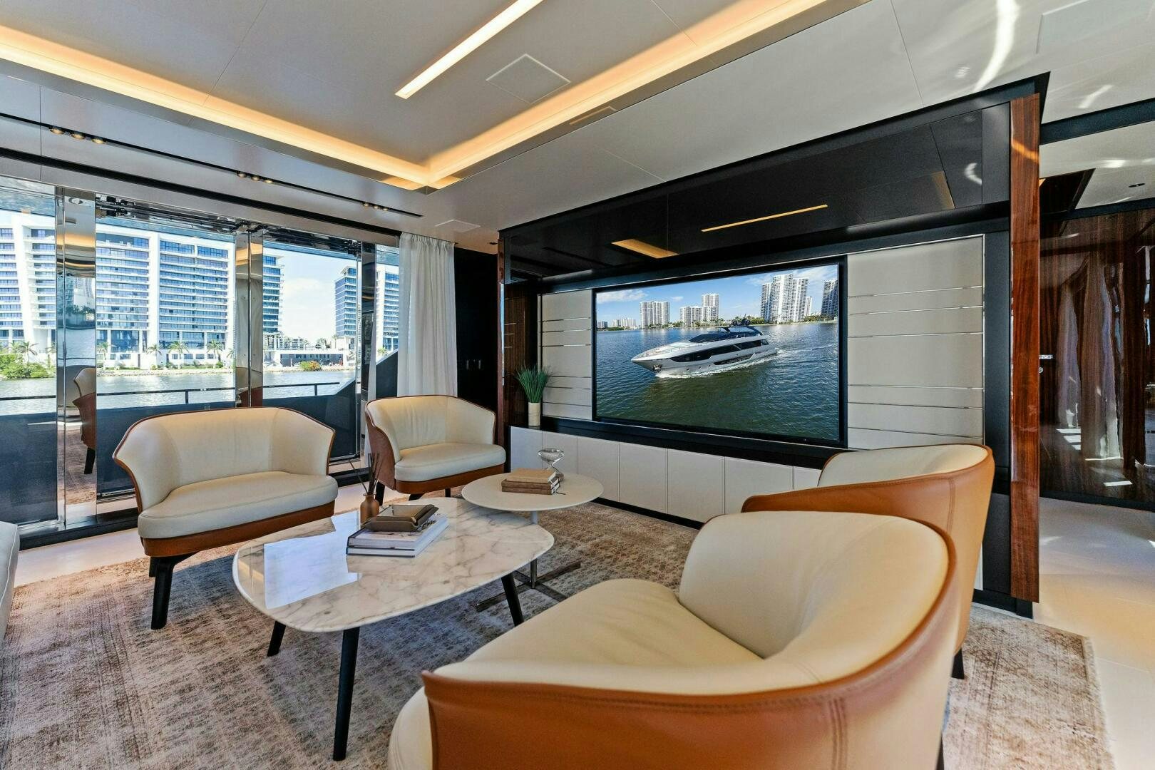 a living room with a large tv aboard CORSARO SUPER Yacht for Sale