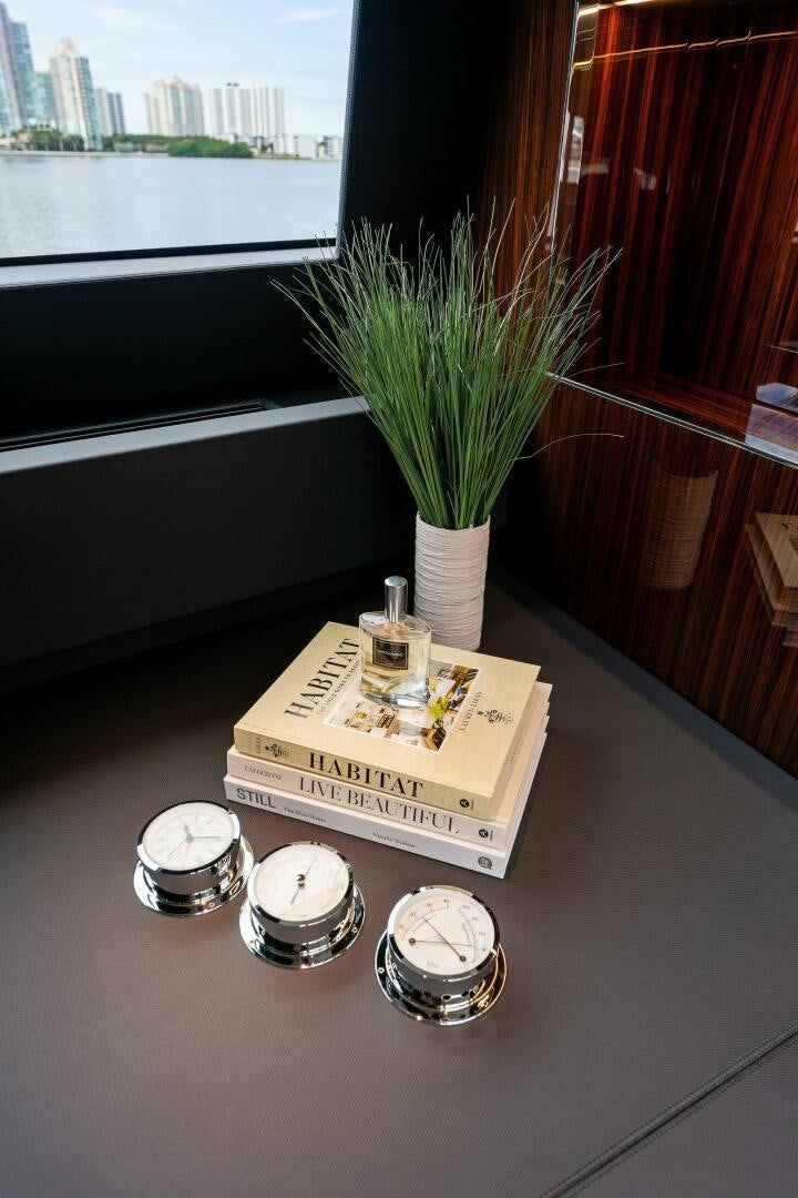 a table with a plant and a box with a candle on it aboard CORSARO SUPER Yacht for Sale