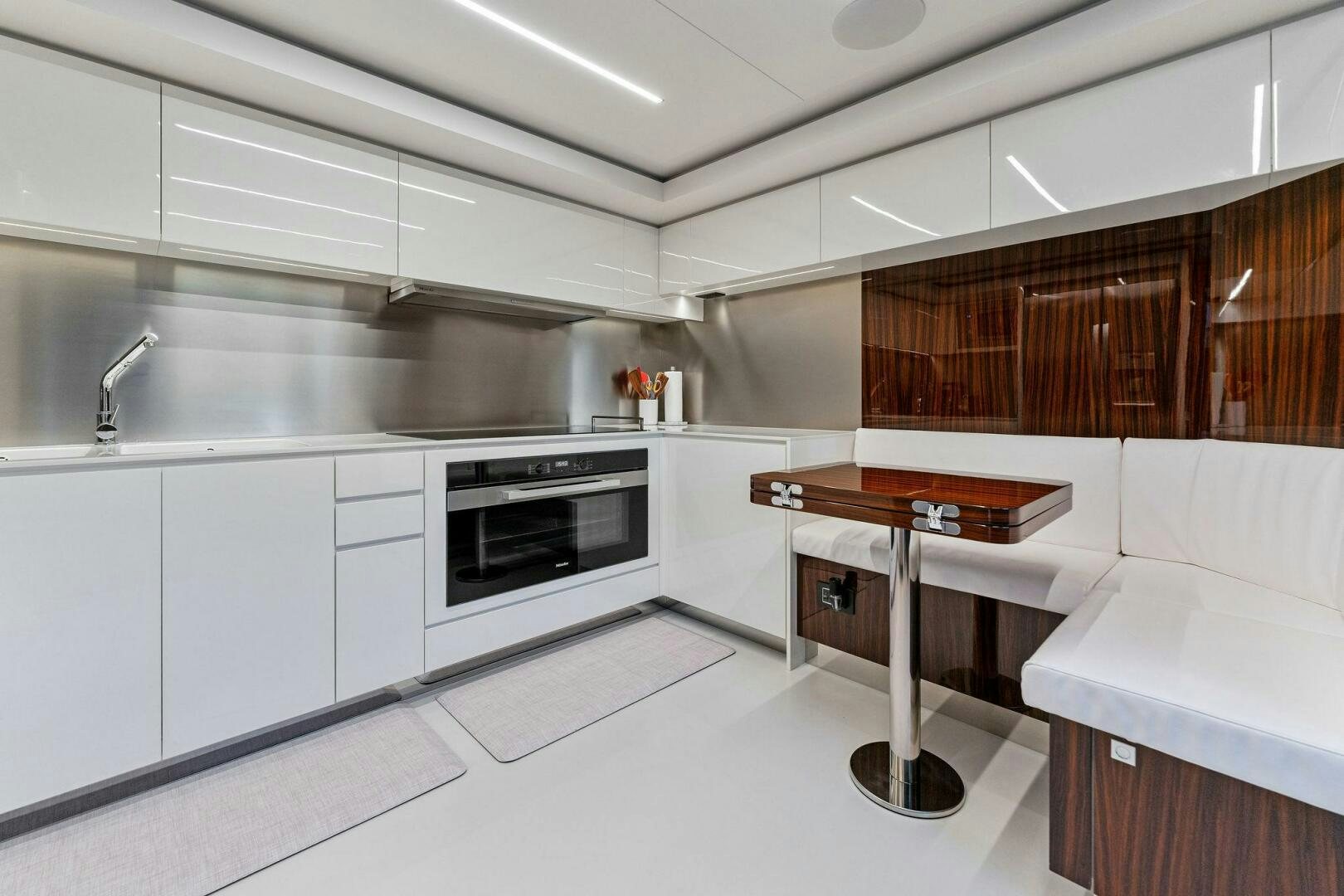 a kitchen with white cabinets aboard CORSARO SUPER Yacht for Sale