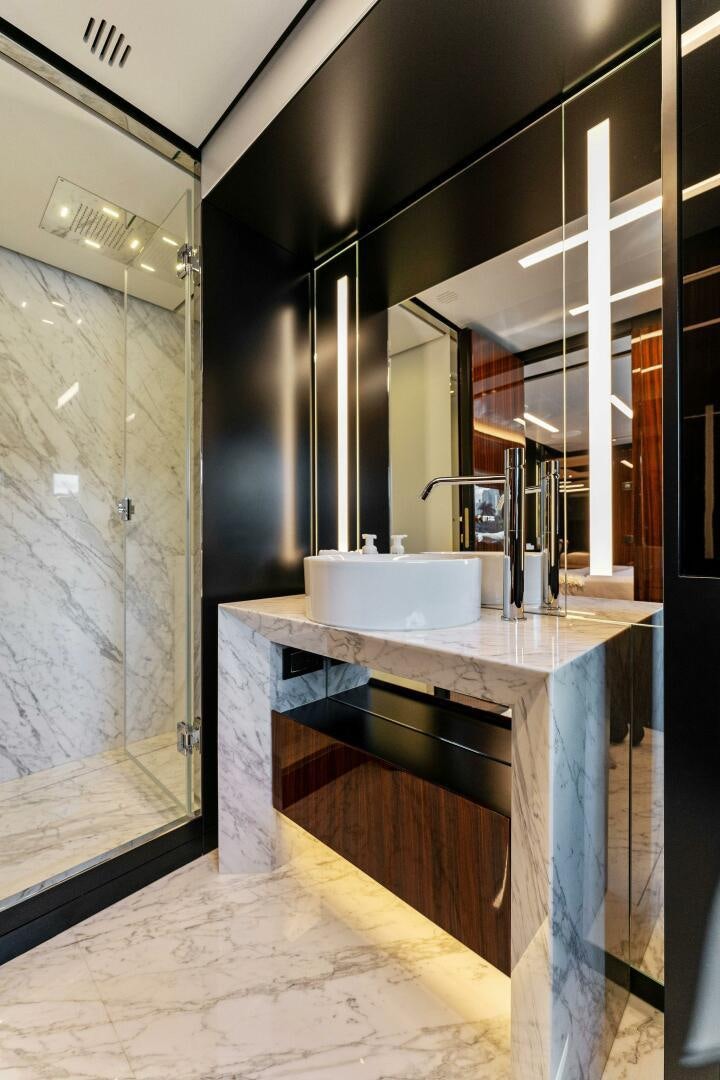 a bathroom with a sink and a large mirror aboard CORSARO SUPER Yacht for Sale