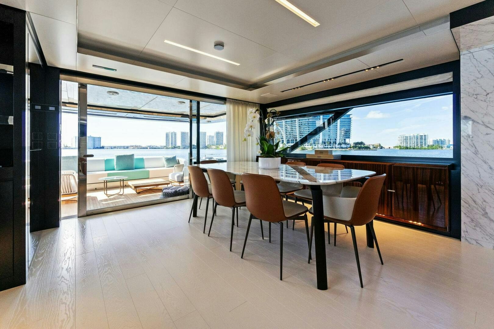 a room with tables and chairs aboard CORSARO SUPER Yacht for Sale