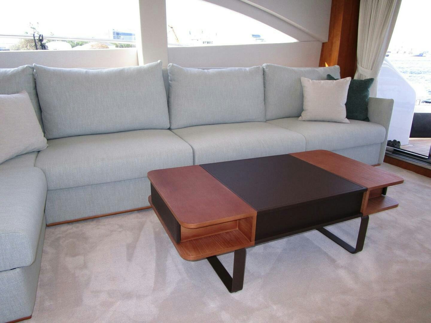 a couch with a coffee table aboard NEW 70 JOHNSON Yacht for Sale