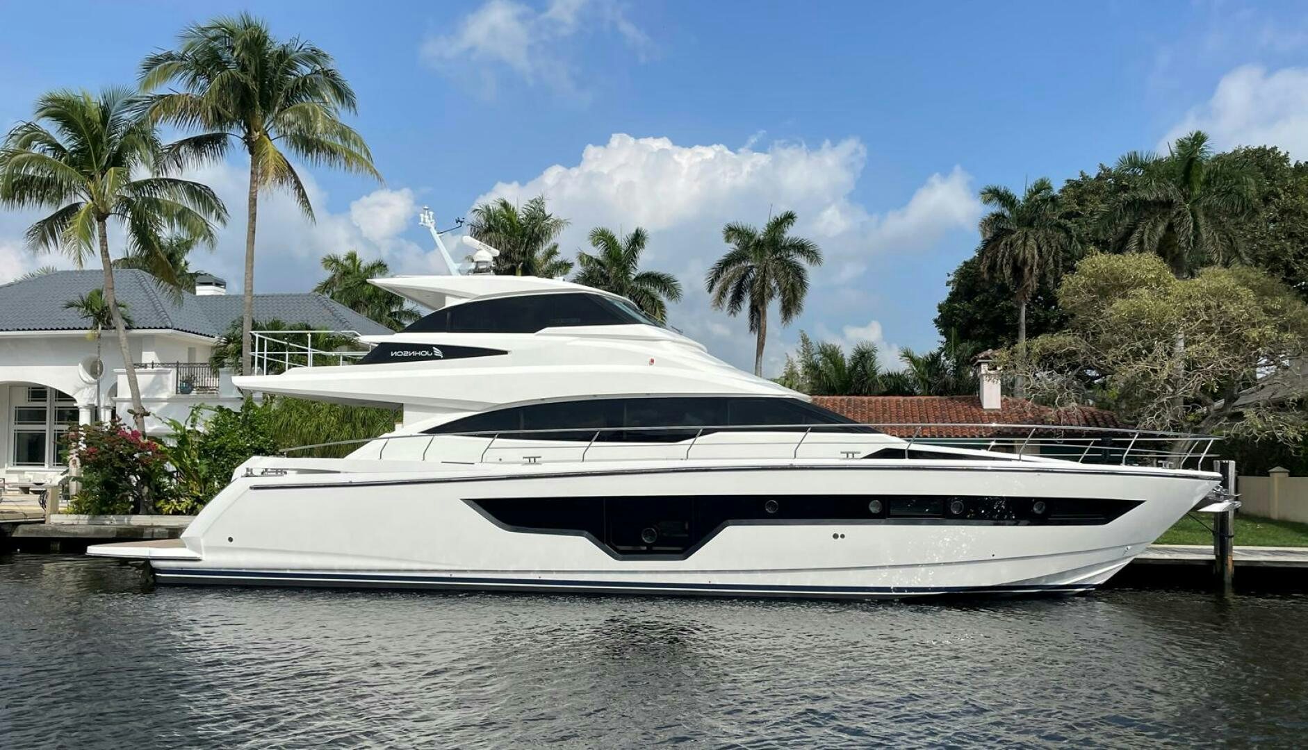 a white yacht on a beach aboard NEW 70 JOHNSON Yacht for Sale