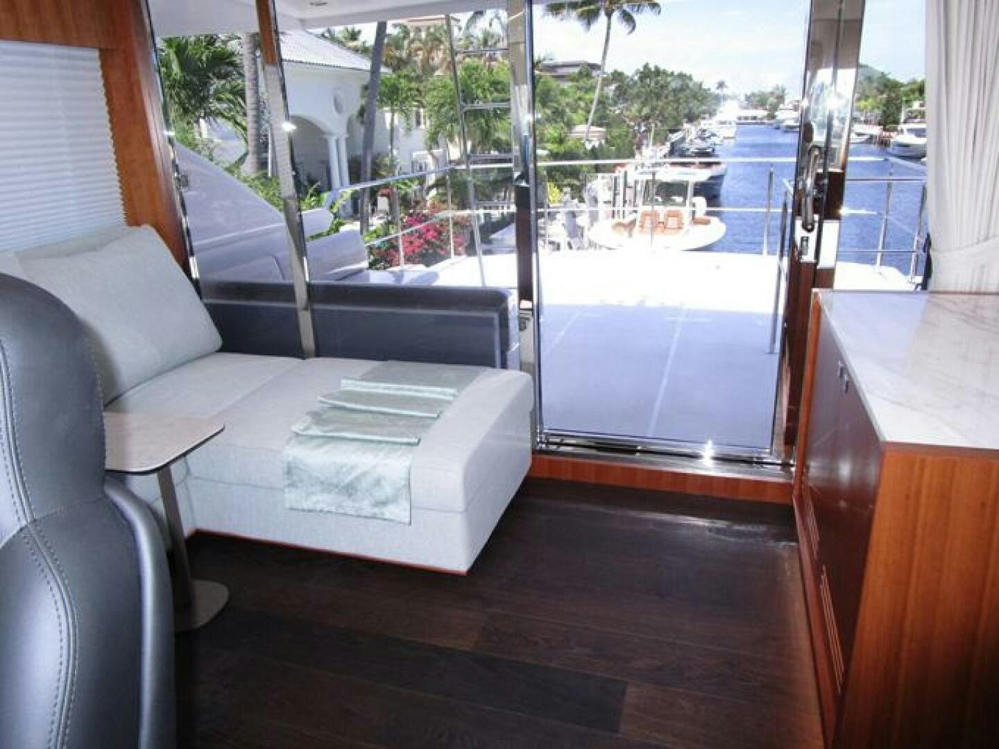 a couch and a table in a room with a window aboard NEW 70 JOHNSON Yacht for Sale
