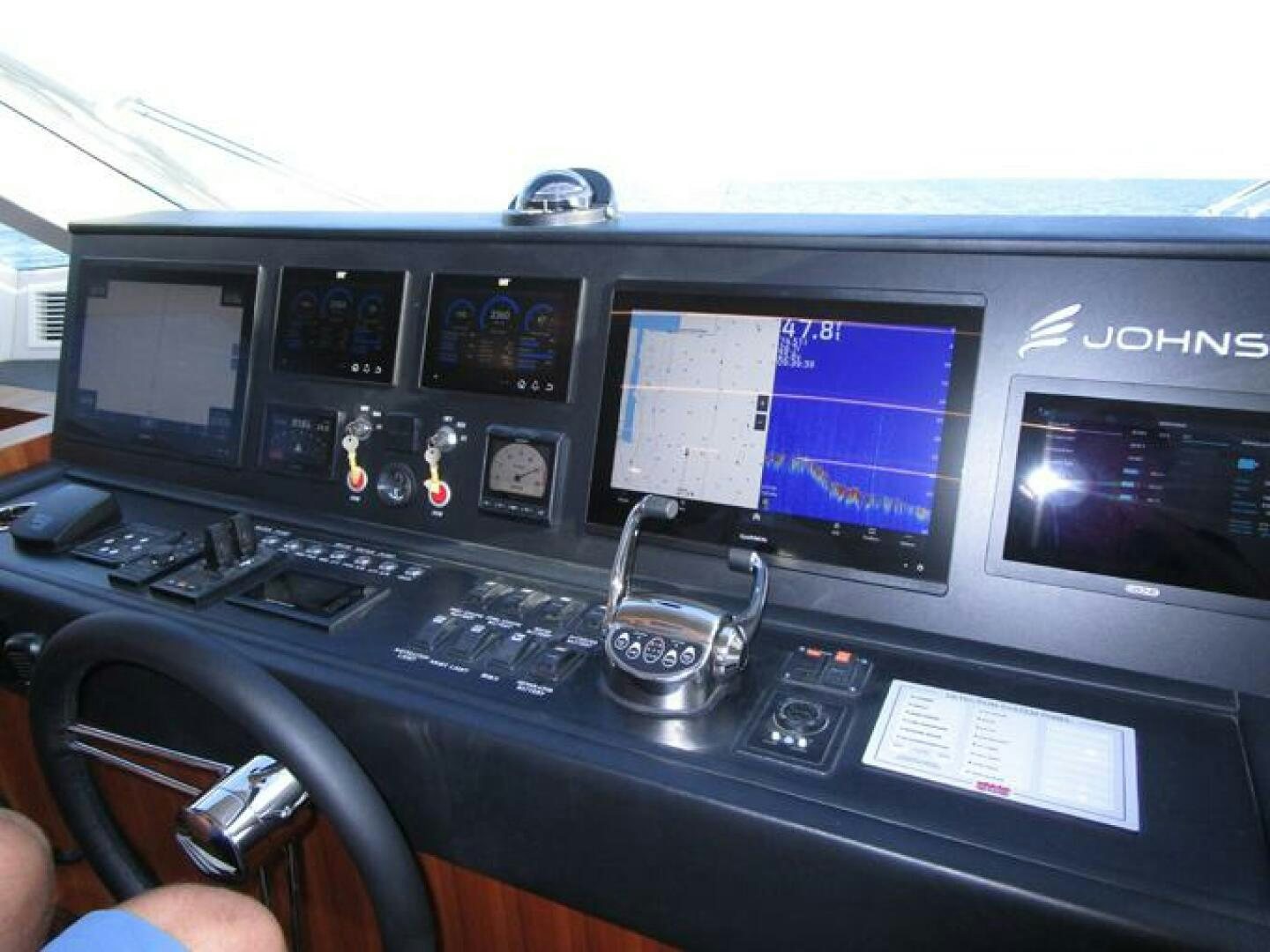 a desk with a computer and other electronic devices on it aboard NEW 70 JOHNSON Yacht for Sale