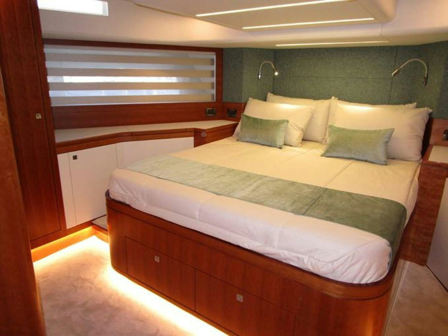 a bed with a white sheet aboard NEW 70 JOHNSON Yacht for Sale