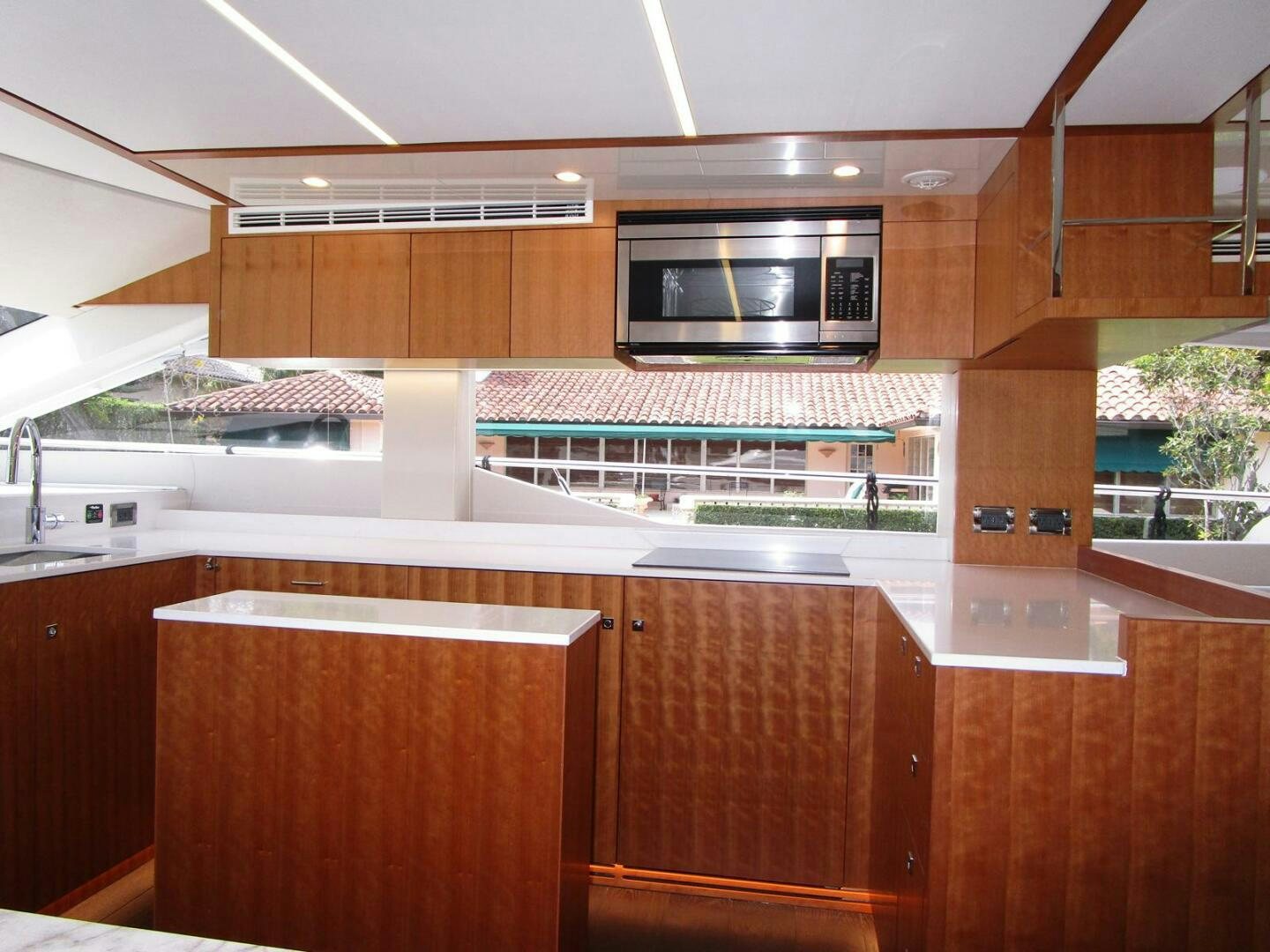 a kitchen with wooden cabinets aboard NEW 70 JOHNSON Yacht for Sale