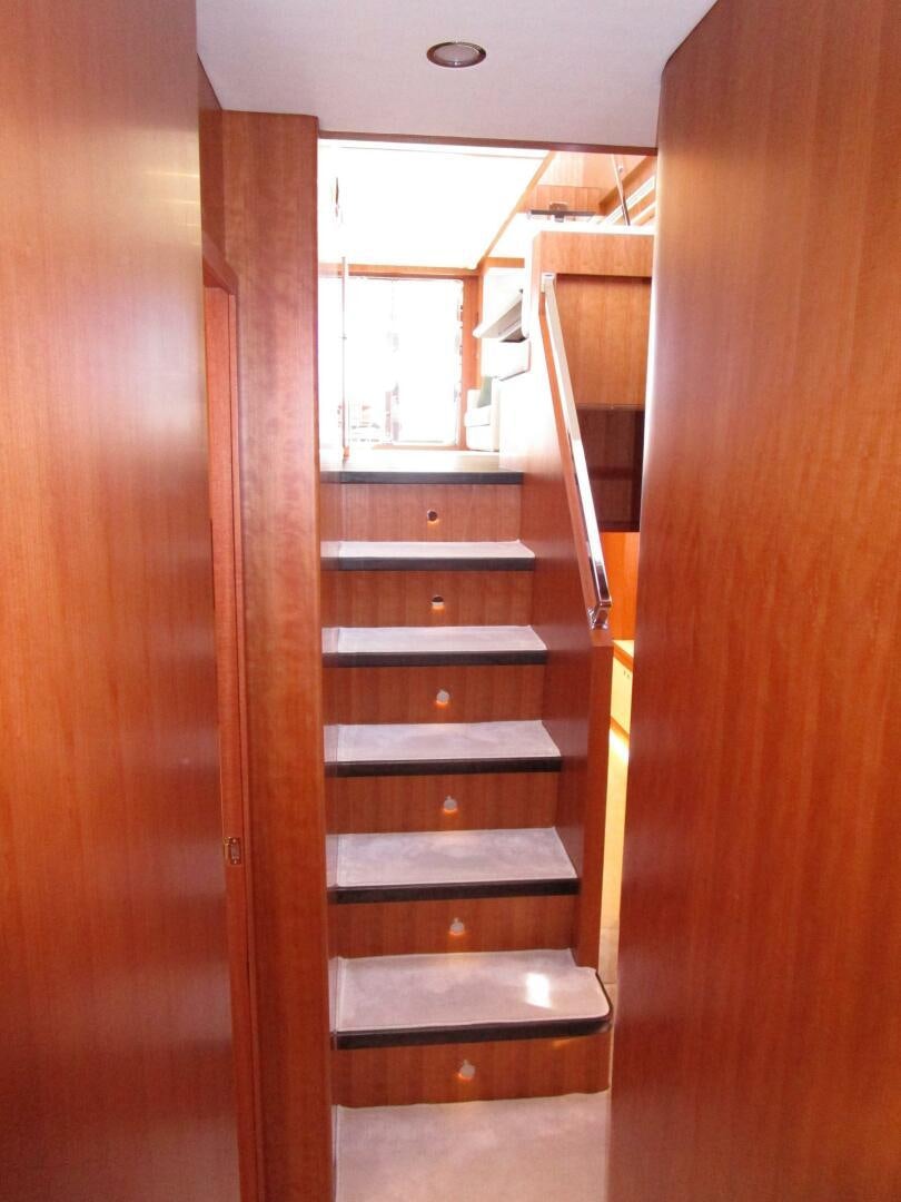 a wooden staircase in a building aboard NEW 70 JOHNSON Yacht for Sale