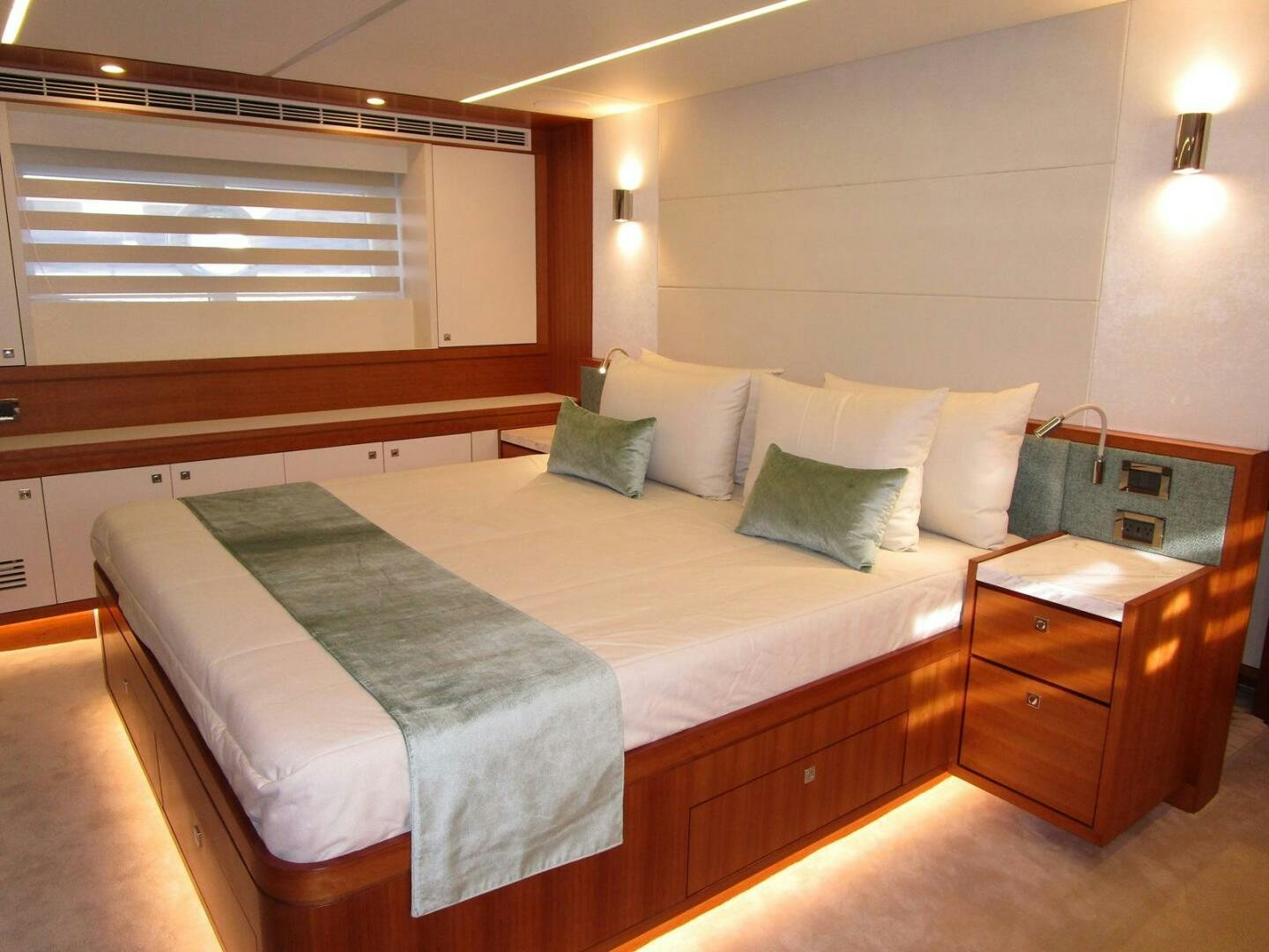a bed with a white comforter aboard NEW 70 JOHNSON Yacht for Sale