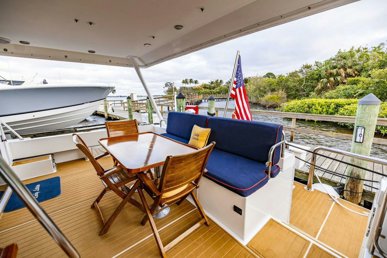 a table and chairs on a deck aboard LADY LETICIA V Yacht for Sale