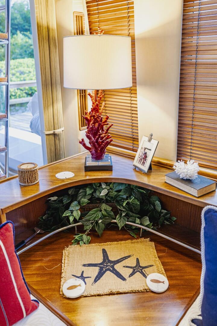 a table with a lamp and a plant on it aboard LADY LETICIA V Yacht for Sale