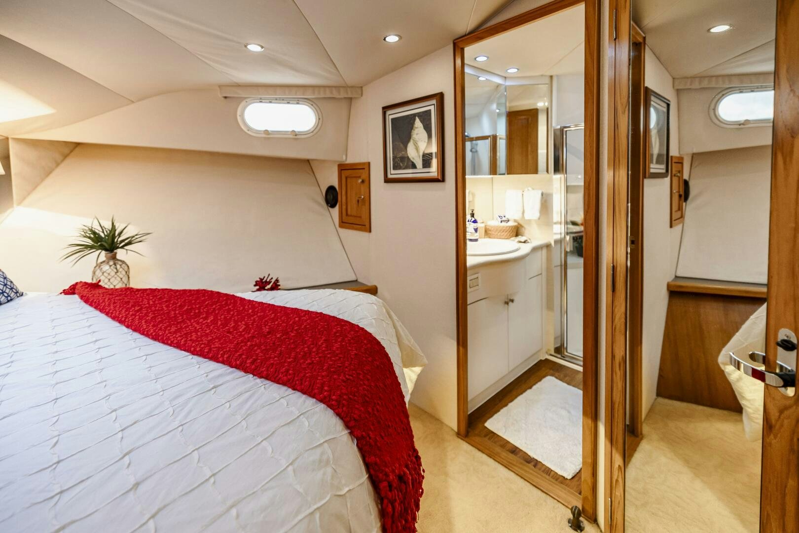 a bedroom with a bed and a mirror aboard LADY LETICIA V Yacht for Sale