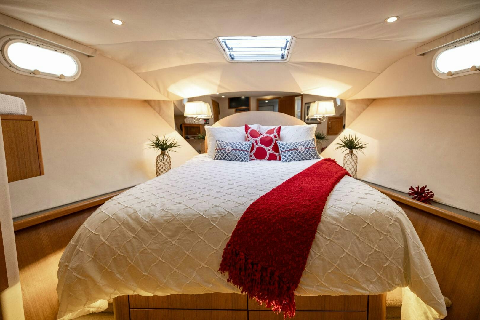a bed with a flowered pillow aboard LADY LETICIA V Yacht for Sale
