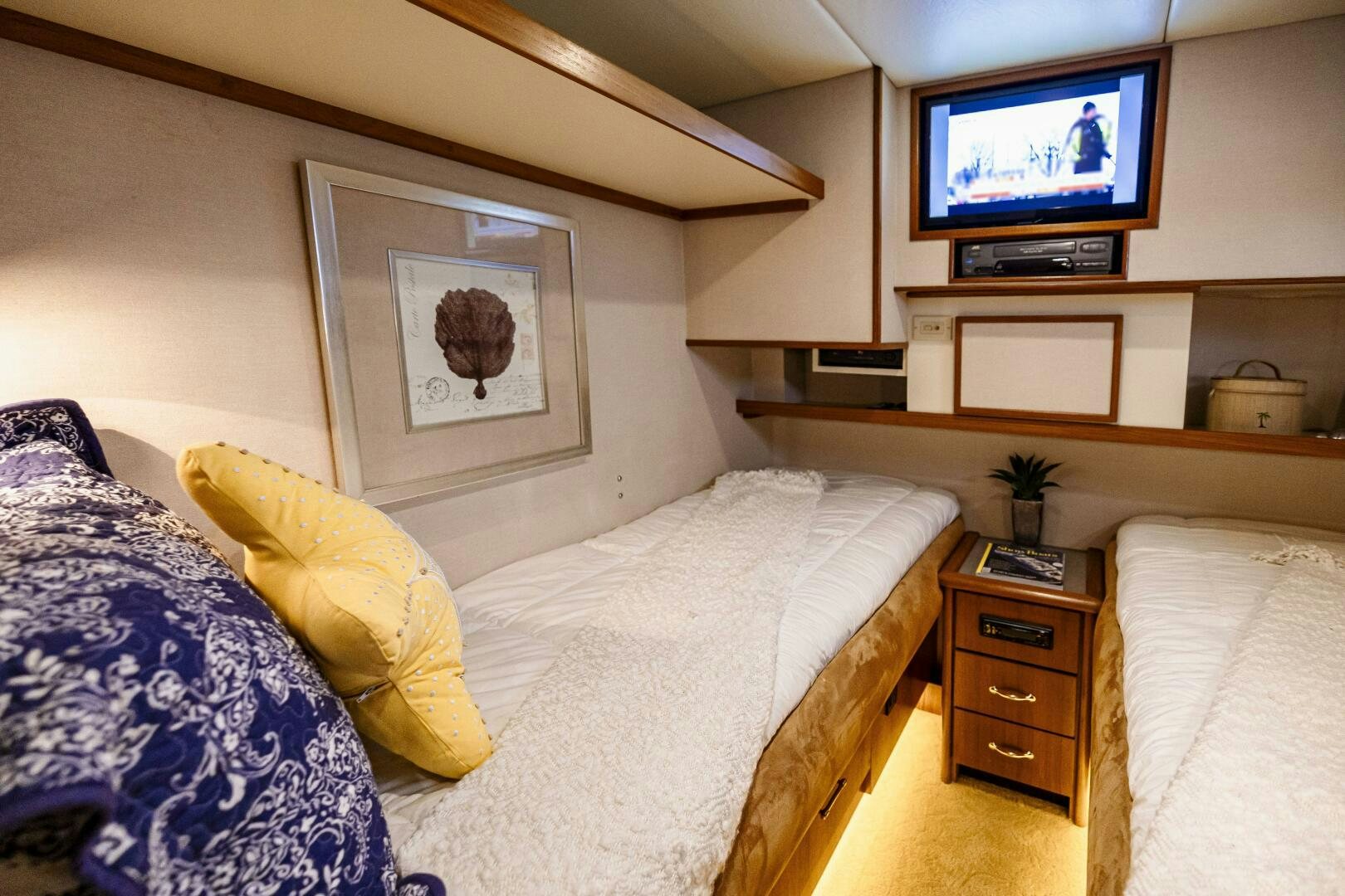 a bedroom with a television and a bed aboard LADY LETICIA V Yacht for Sale