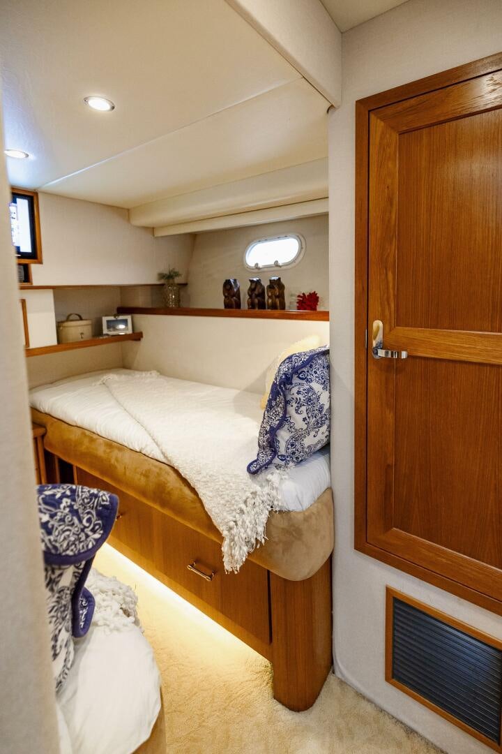 a bedroom with a bed and a closet aboard LADY LETICIA V Yacht for Sale
