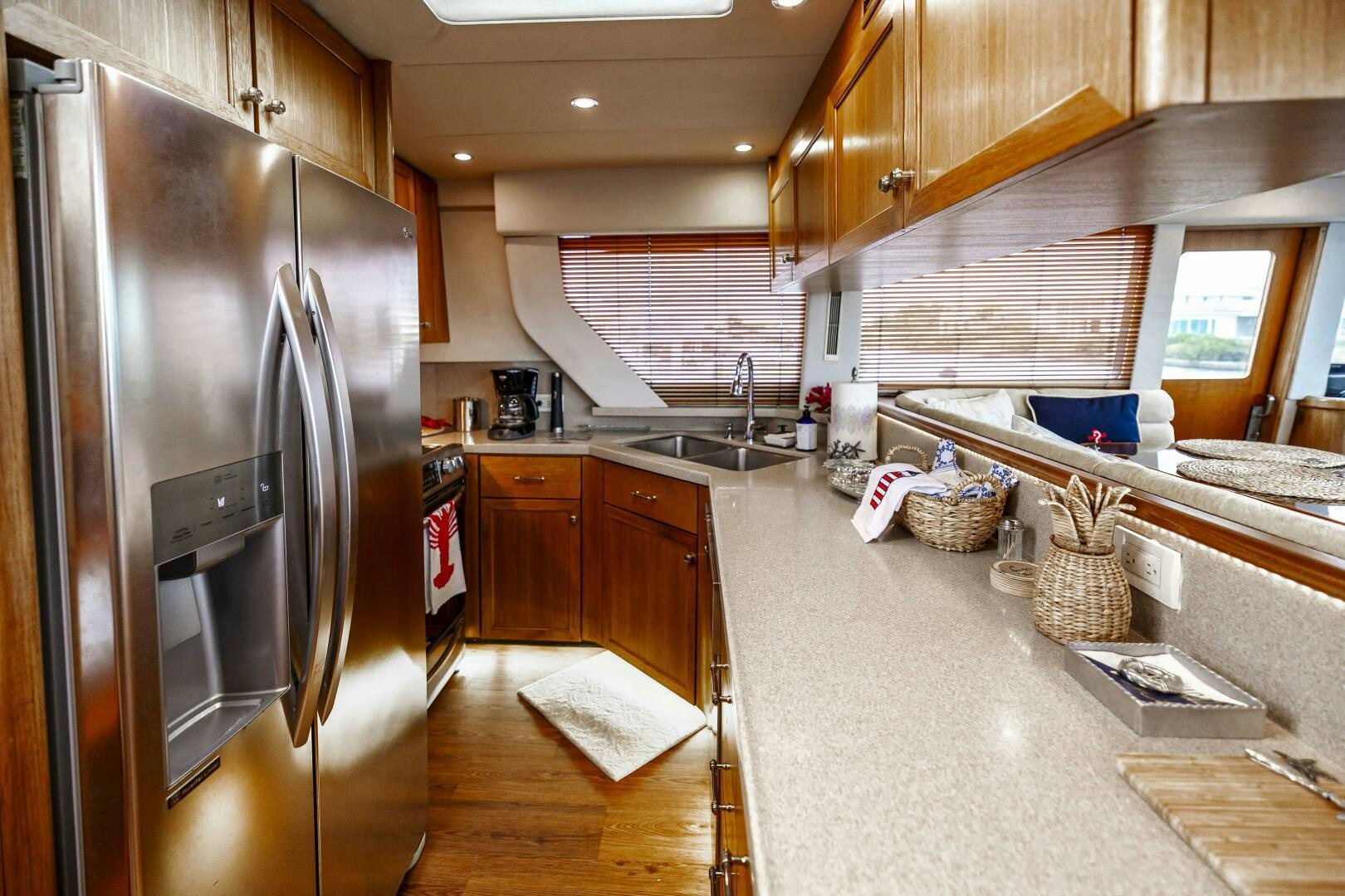 a kitchen with a stainless steel refrigerator aboard LADY LETICIA V Yacht for Sale