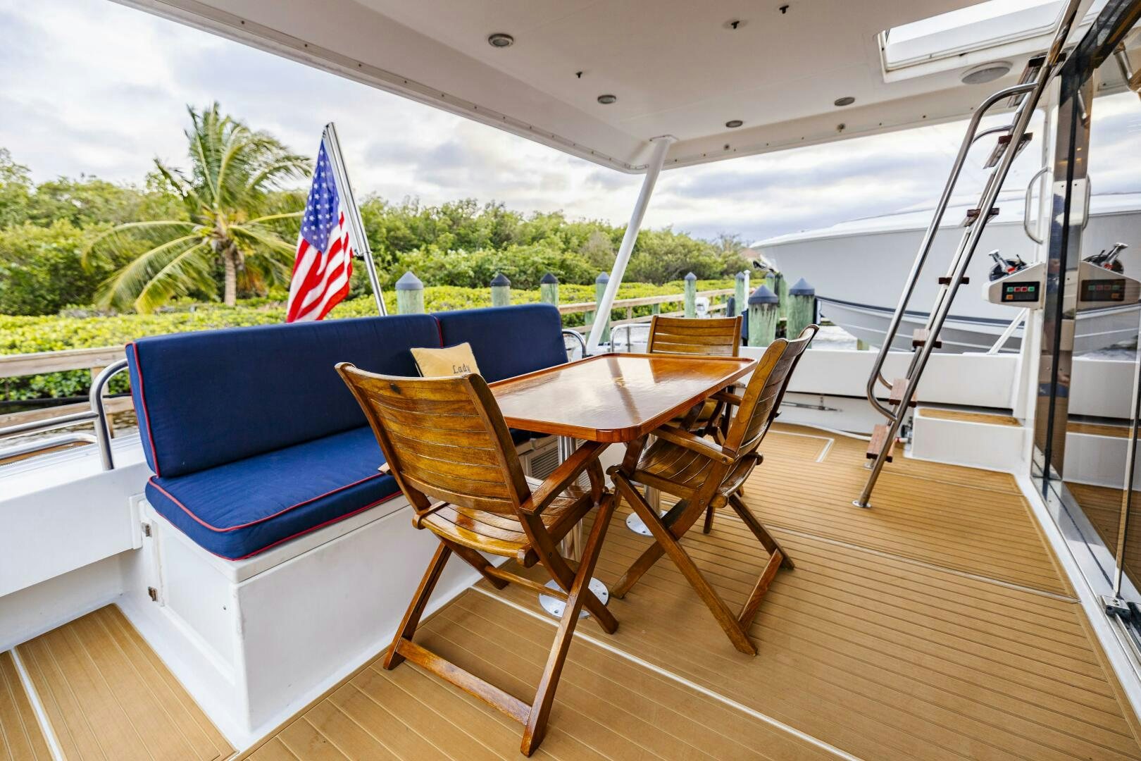 a table and chairs on a deck aboard LADY LETICIA V Yacht for Sale