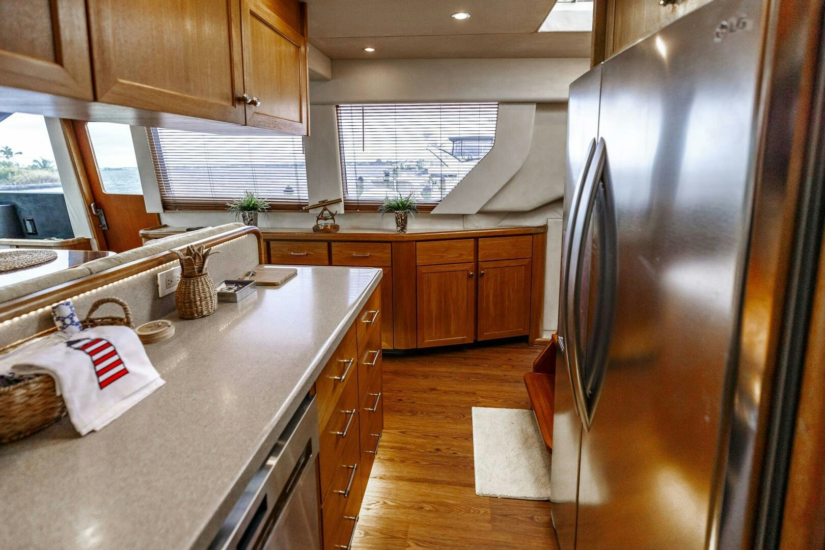 a kitchen with a stainless steel refrigerator aboard LADY LETICIA V Yacht for Sale