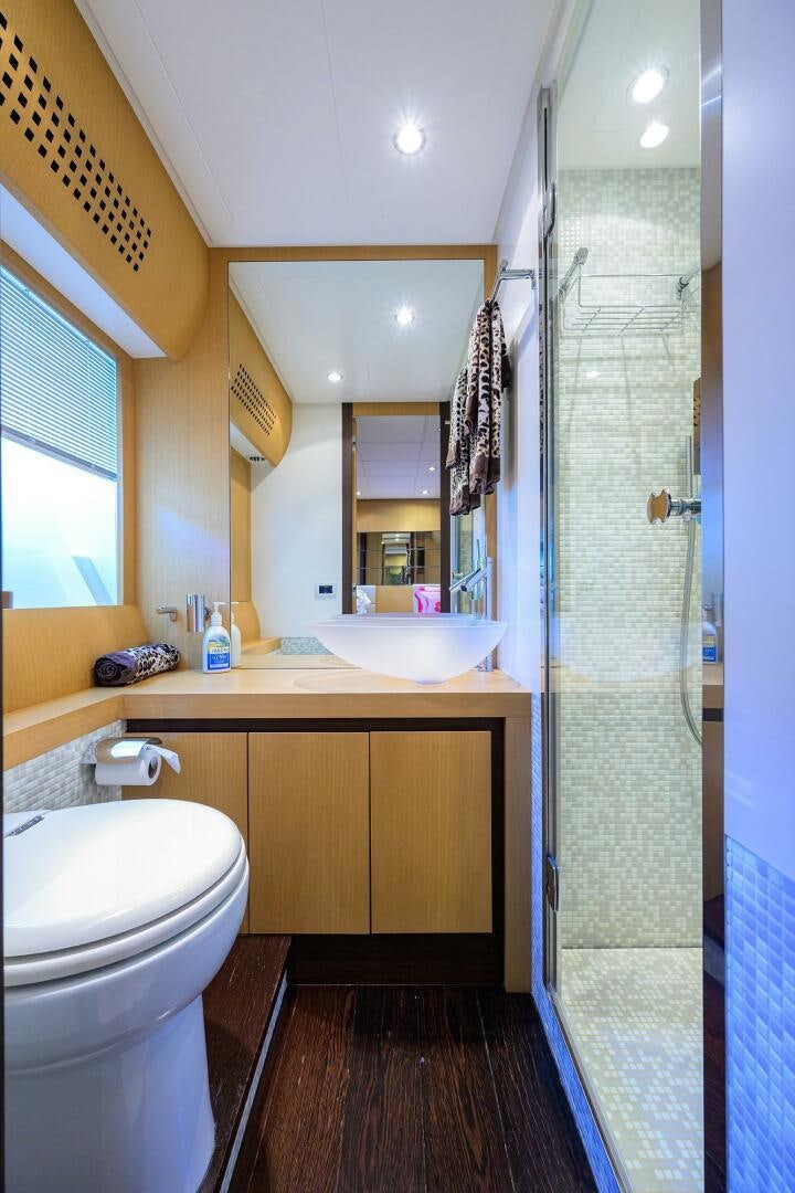 a bathroom with a glass shower aboard MIURA Yacht for Sale
