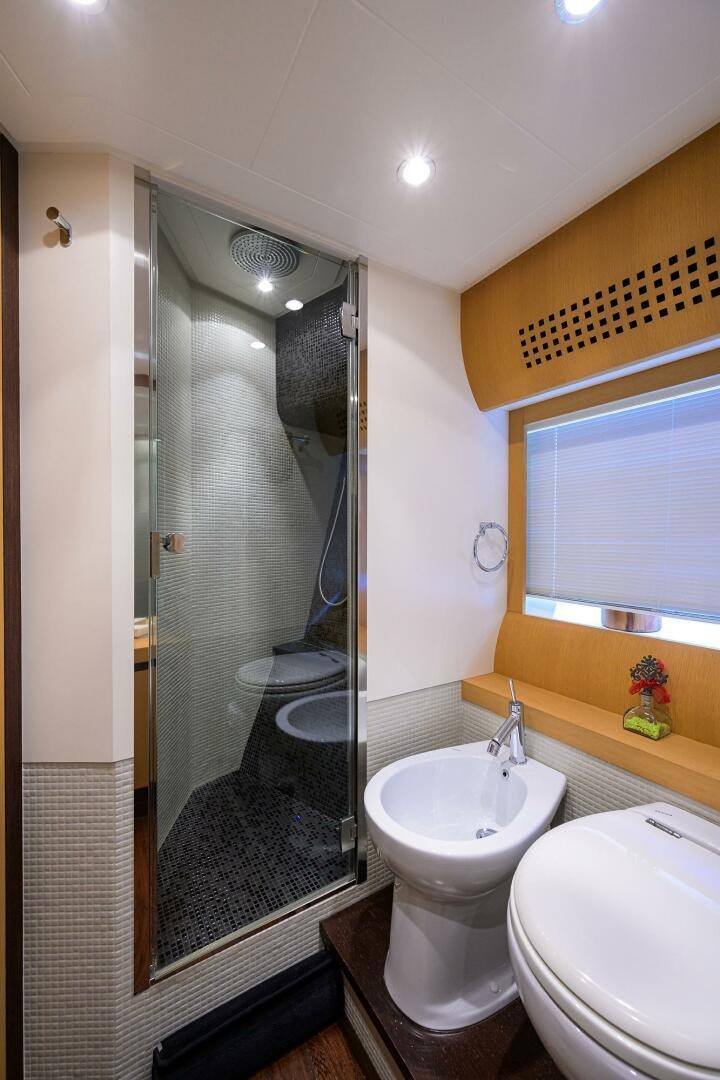 a bathroom with a glass shower door aboard MIURA Yacht for Sale