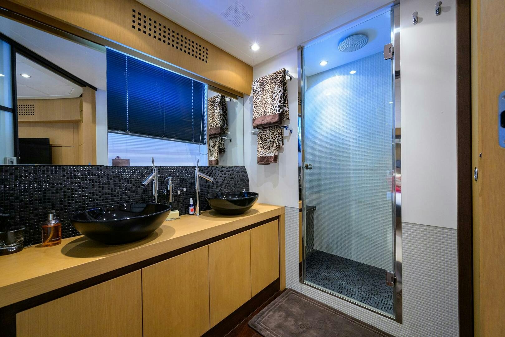 a bathroom with a large glass shower aboard MIURA Yacht for Sale