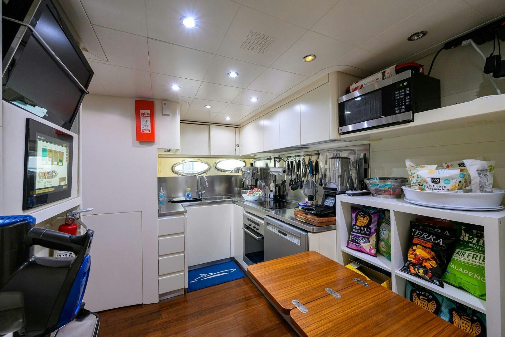 a kitchen with a table and shelves aboard MIURA Yacht for Sale