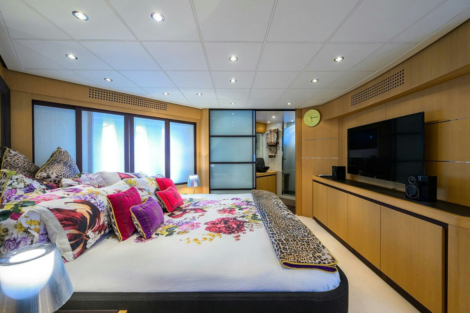 a bedroom with a bed and a tv aboard MIURA Yacht for Sale