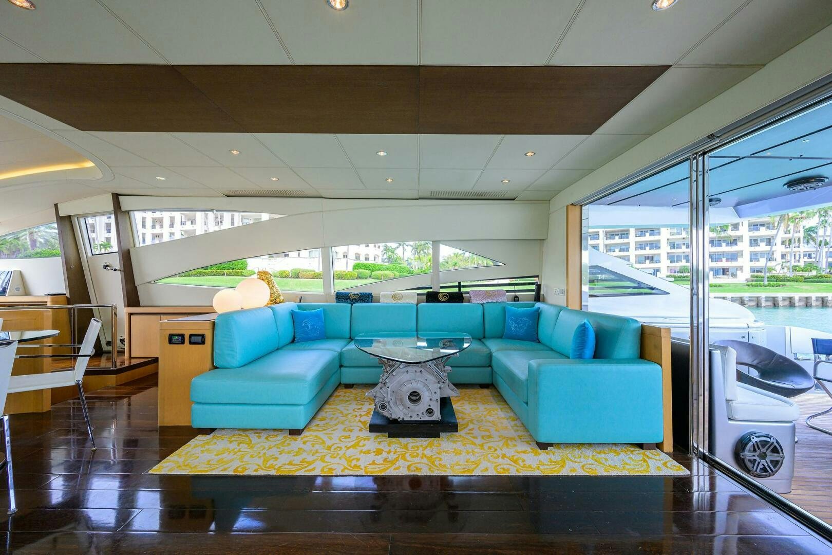 a living room with a blue couch aboard MIURA Yacht for Sale