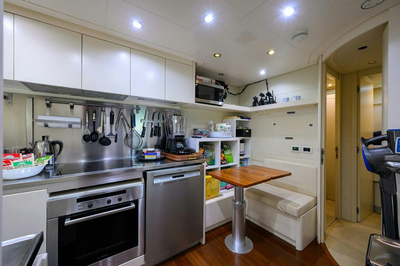 a kitchen with white cabinets aboard MIURA Yacht for Sale